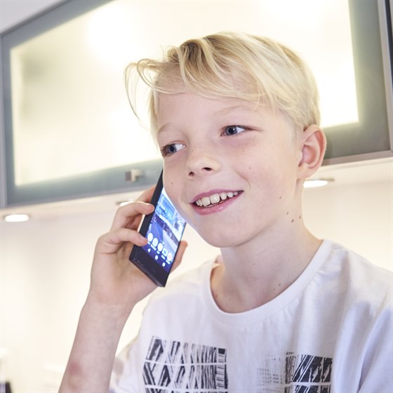 Dreng taler i mobiltelefon