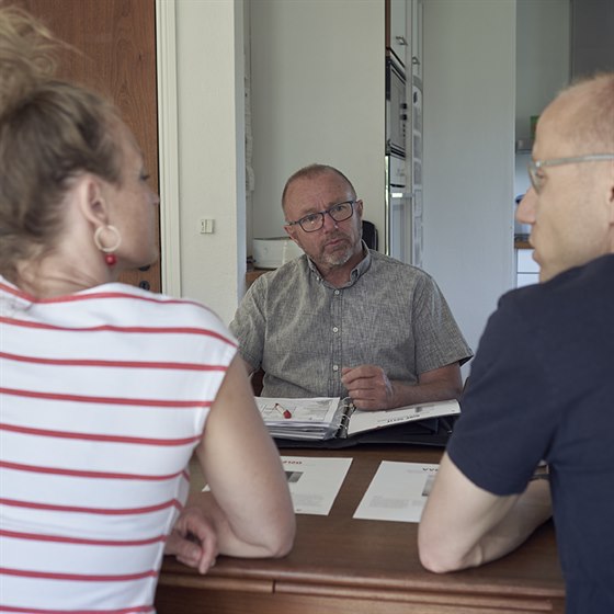 Mand lytter til par der taler om varmepumper